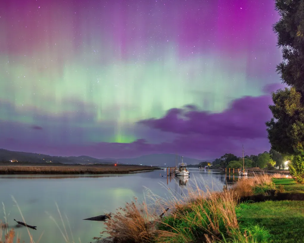 Aurora Australis over the Huon River beside Boat Reflections in Franklin, Tasmania, photographed by Josh Withers